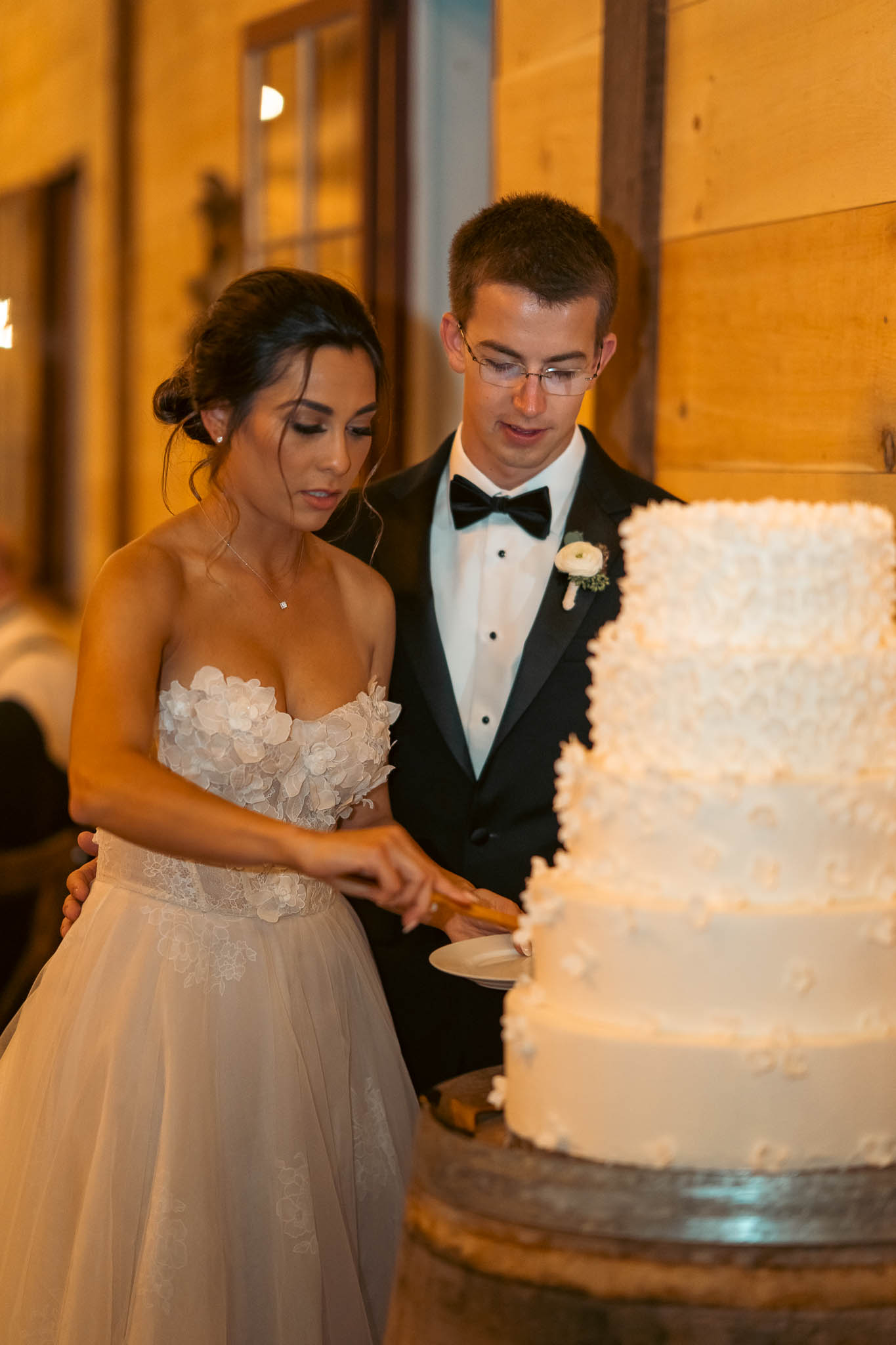 Bride and groom cutting the cake at the barn reception — Sylvanside Farm wedding in Purcellville, Virginia