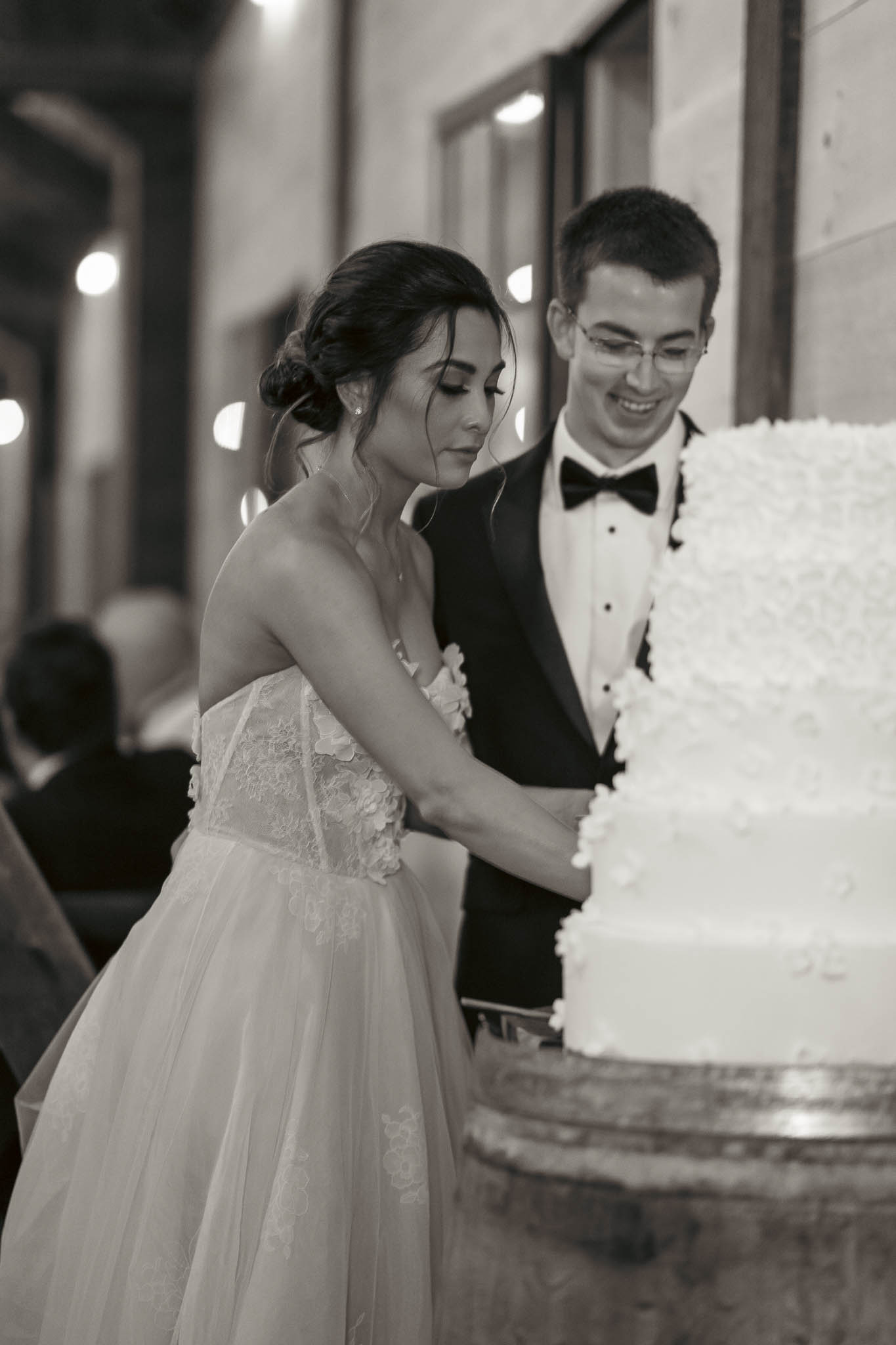 Cake cutting under the barn lights — Sylvanside Farm wedding in Purcellville, Virginia