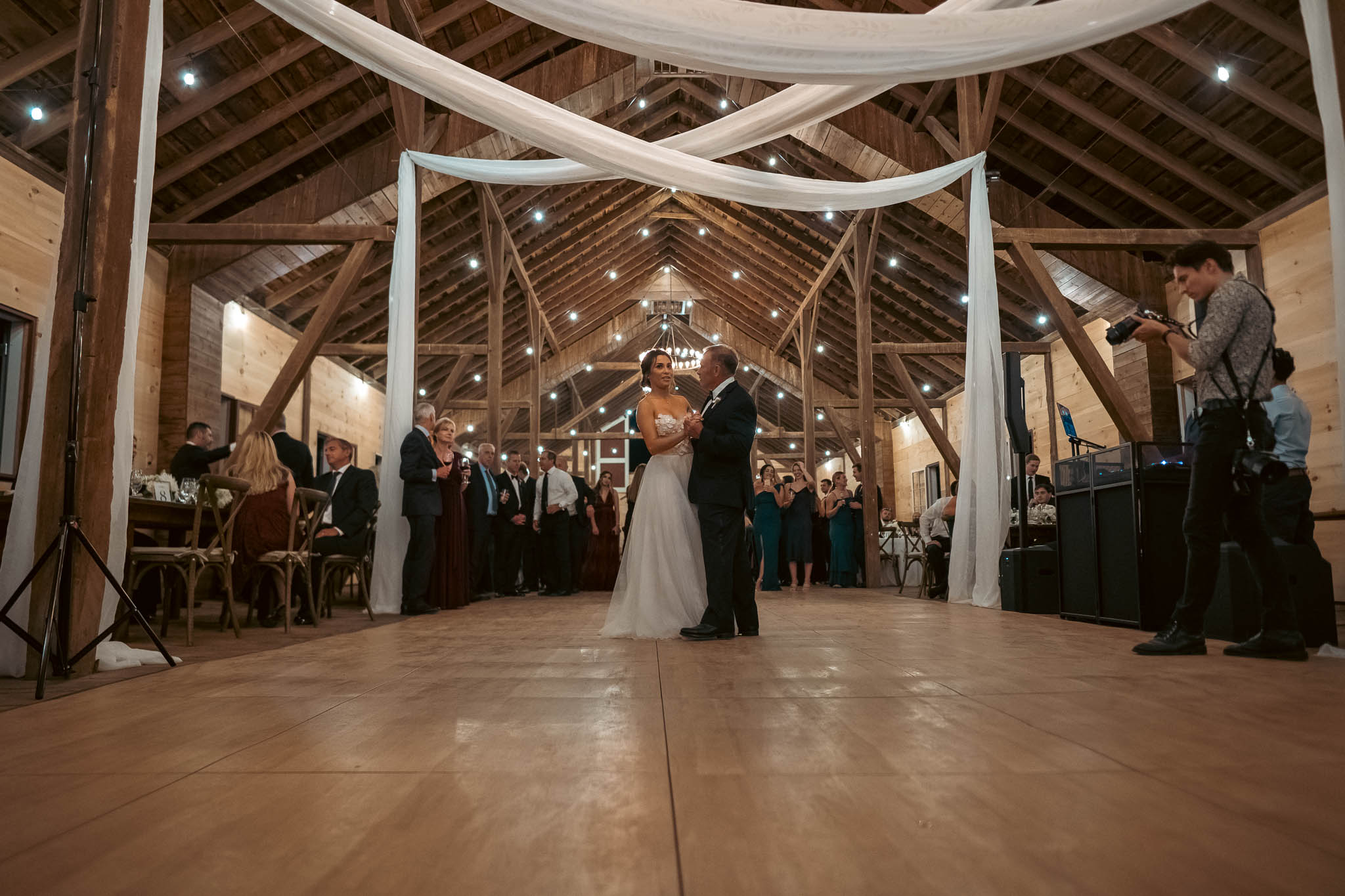 Mother-son dance under the barn string lights — Sylvanside Farm wedding in Purcellville, Virginia