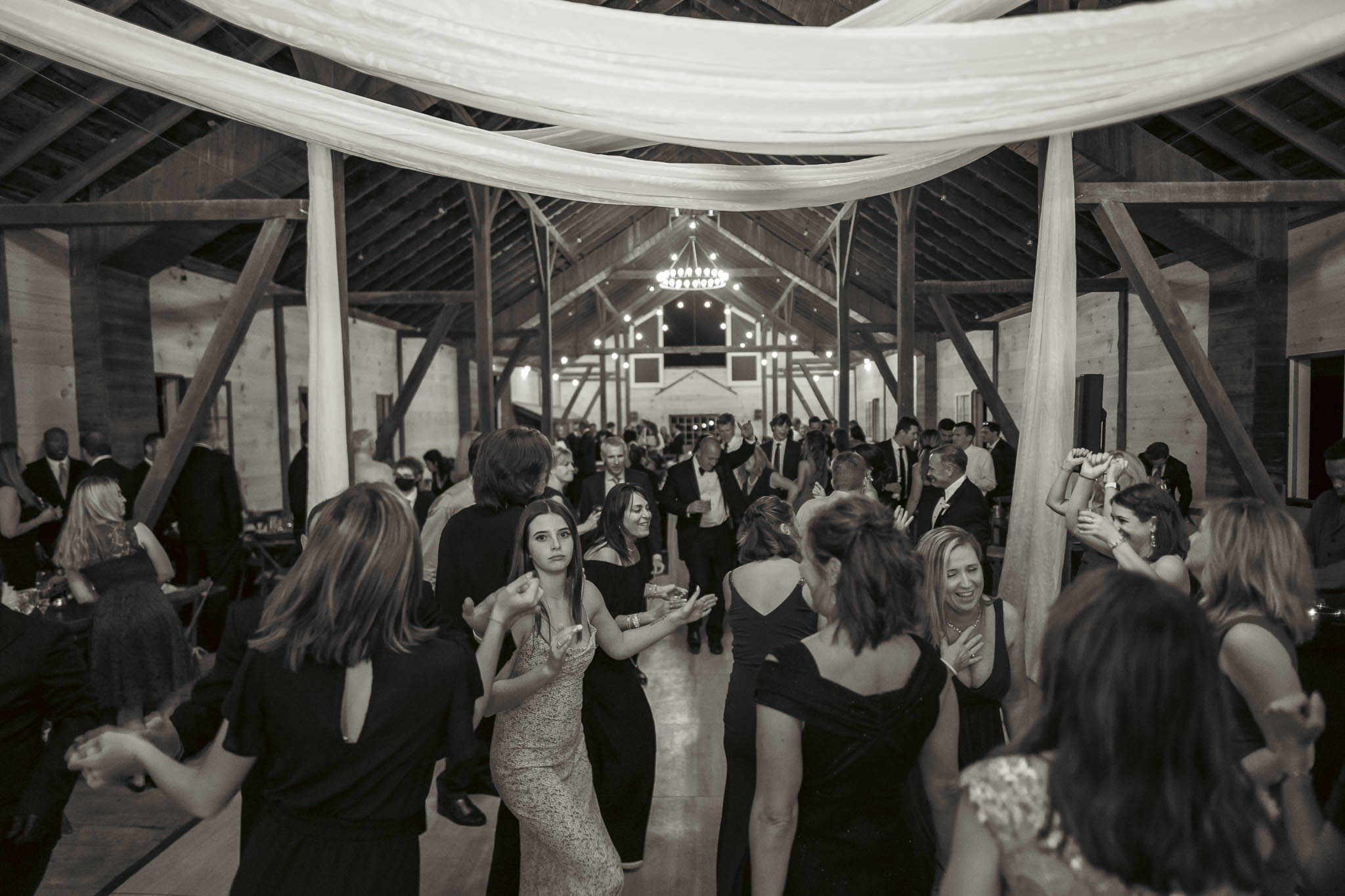 Guests filling the dance floor in the barn — Sylvanside Farm wedding in Purcellville, Virginia