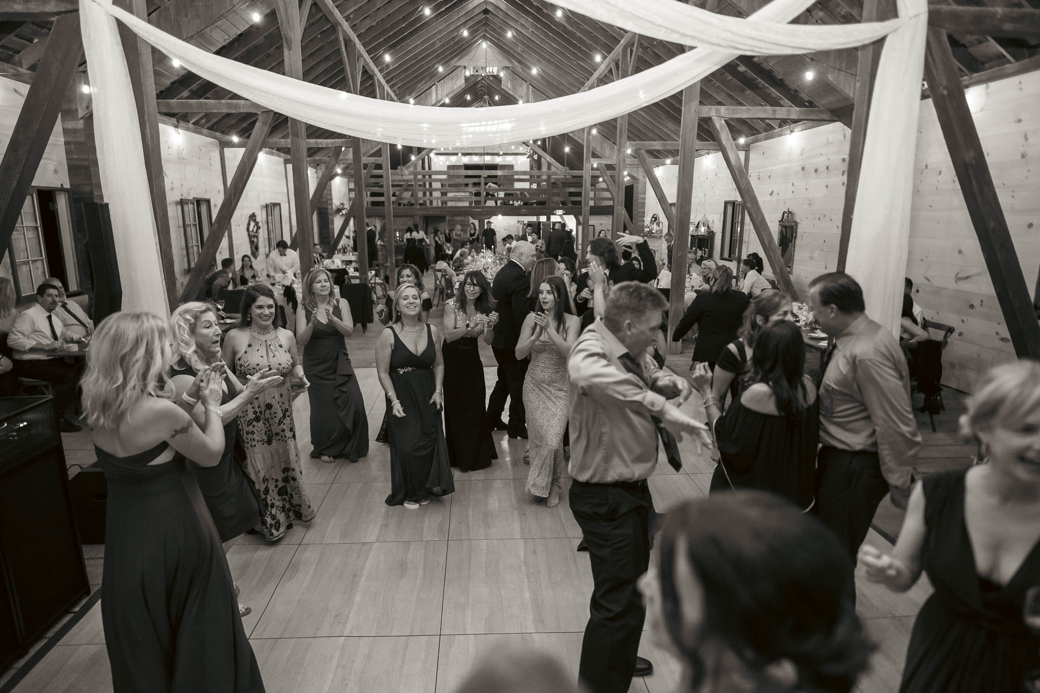 Late-night dancing under the draped barn ceiling — Sylvanside Farm wedding in Purcellville, Virginia
