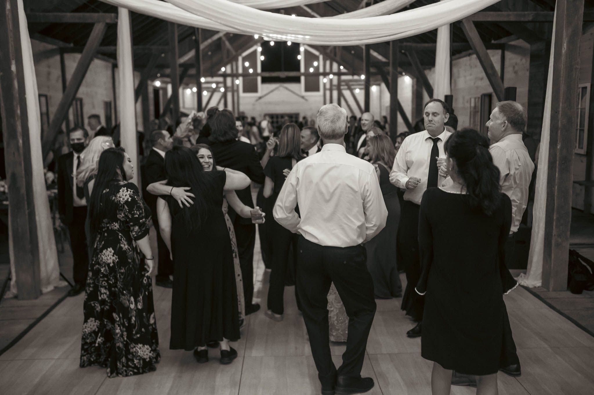 Late-night dancing under the draped barn ceiling — Sylvanside Farm wedding in Purcellville, Virginia